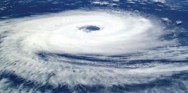 Why do hurricanes spin as they are moving?
